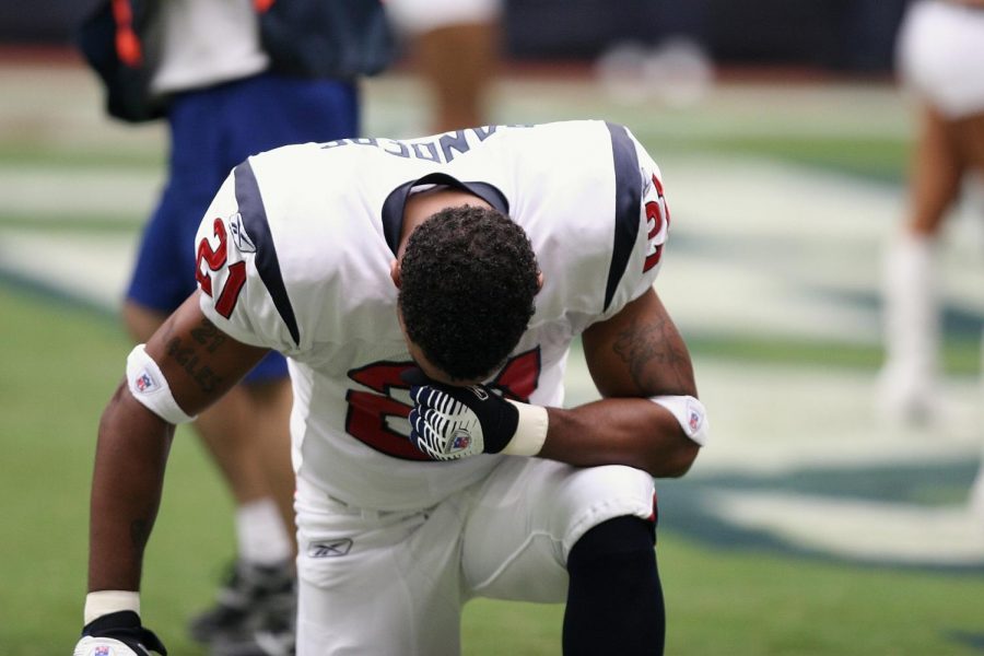 An NFL player takes a knee during a game in the 2017-18 season. Players kneeling during the national anthem became a hot-button topic across the country.