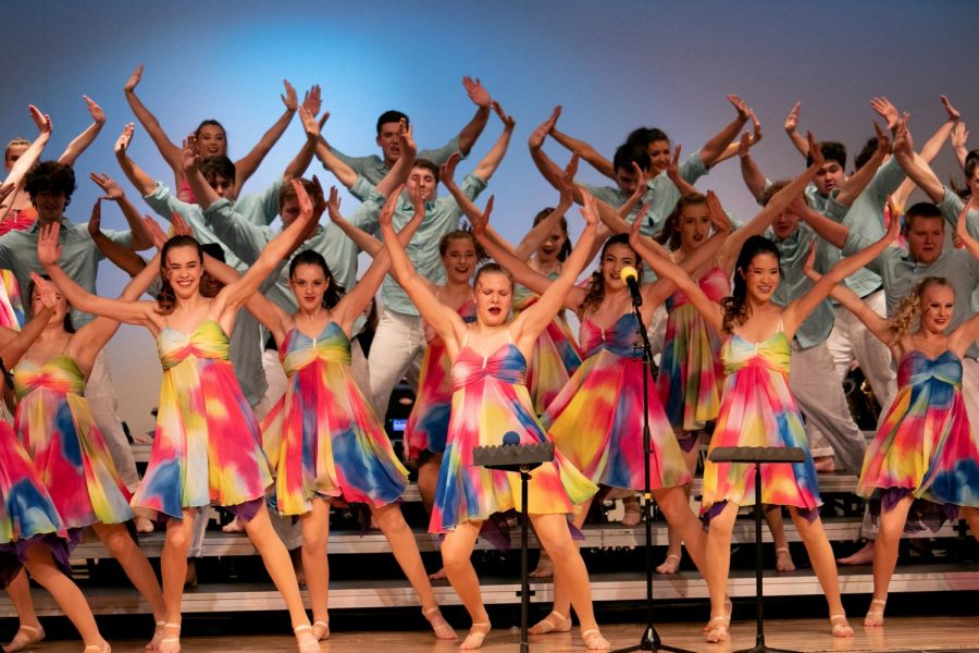 Excel dancing passionately after their costume change to light and flowy attire.