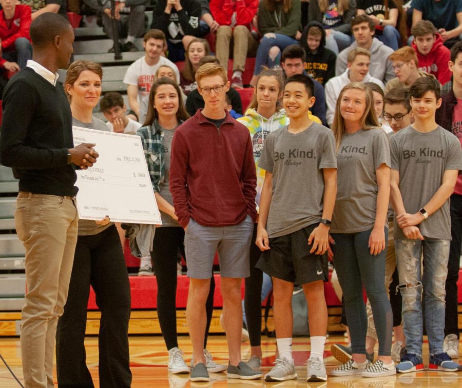 Student Council sponsor Abby Whalen and members of EHS StuCo. present a check for $1,000 to Buey Ray Tut. StuCo sponsors a speaker for the students of EHS each spring.