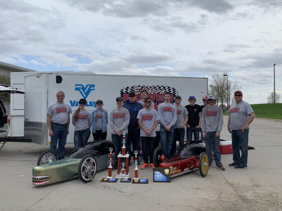 Members of the Power Drive team pose with their cars and sponsors after securing the teams 4th consecutive championship. The team is a co-op with Elkhorn South. 