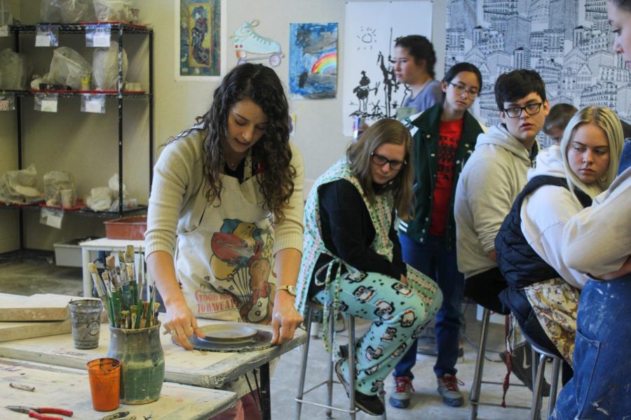 The art teacher, Maddie Rosonke, teaches students how to work with pottery.