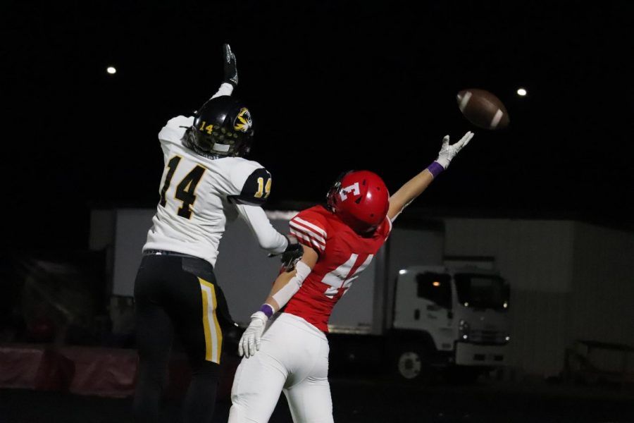 Junior Gannon Gragert reaches to catch a ball while fending off a player from Fremont.