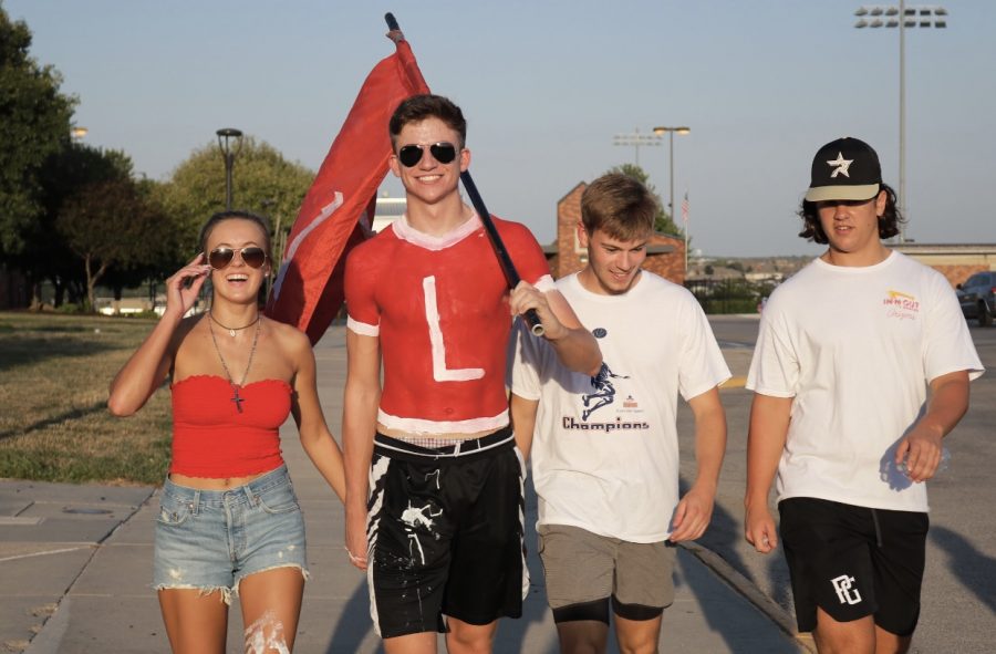 Seniors Lauren Wright, Colton Uhing, Caden Reynolds and Malakai Vetock heading back from watching the player run down to the field.