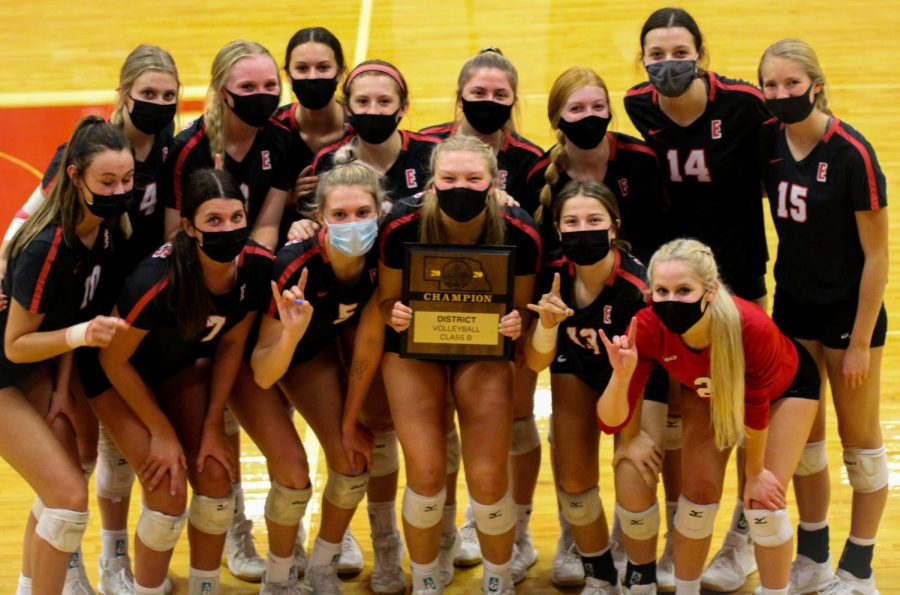 Elkhorn volleyball celebrates with the district plaque. 