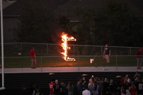 Students watch as the letter E burns during the Burning of the E ceremony. The annual pep rally returned this year after being cancelled for COVID last year.