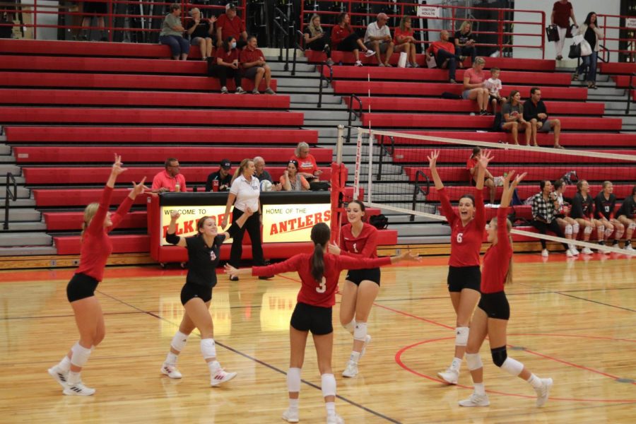 Antlers volleyball team celebrating after scoring a point. 