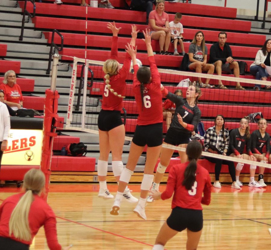 Taylor Bunjer (5) and Haley Wolfe (6) blocking a kill. 