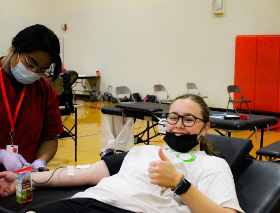 Brianna Bree Christianson gives a thumbs up while donating blood at the annual blood drive. 