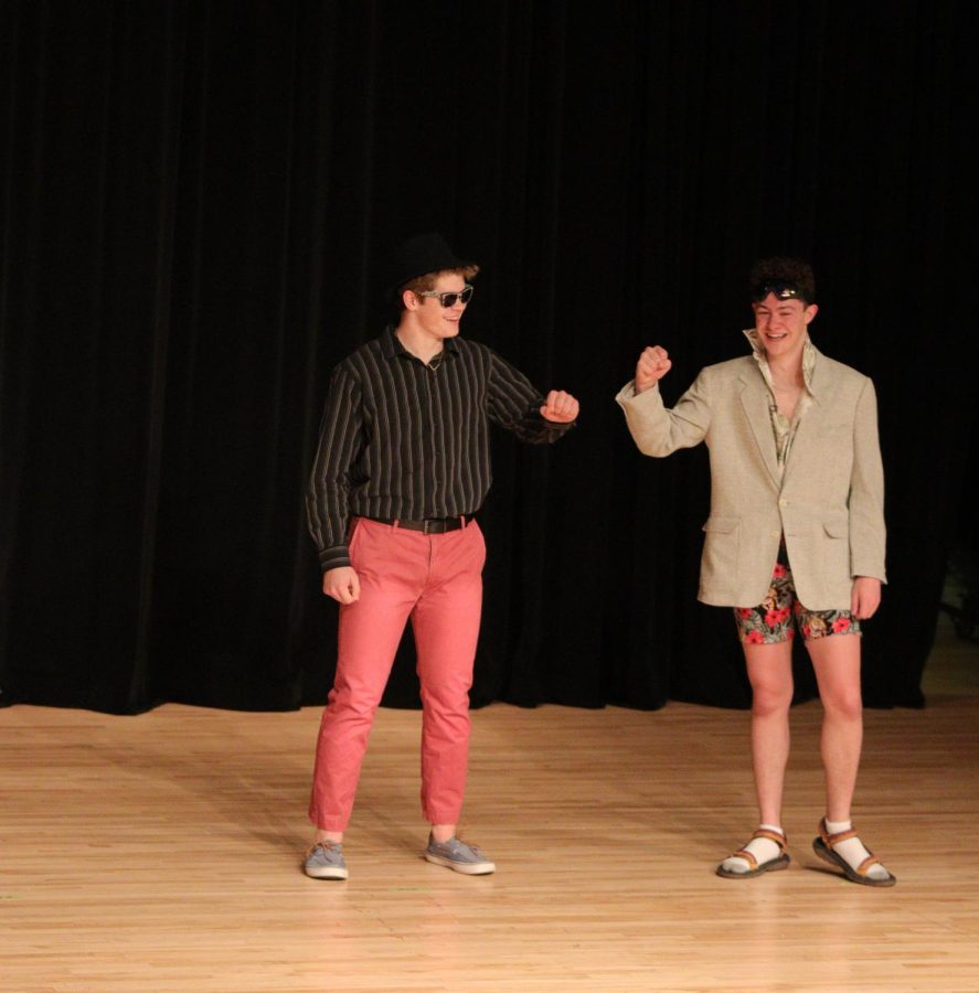 Isaac Workman and Ben Kubicek go to fist-bump each other while admiring their outfits. They competed together during the Mr.EHS pageant. 