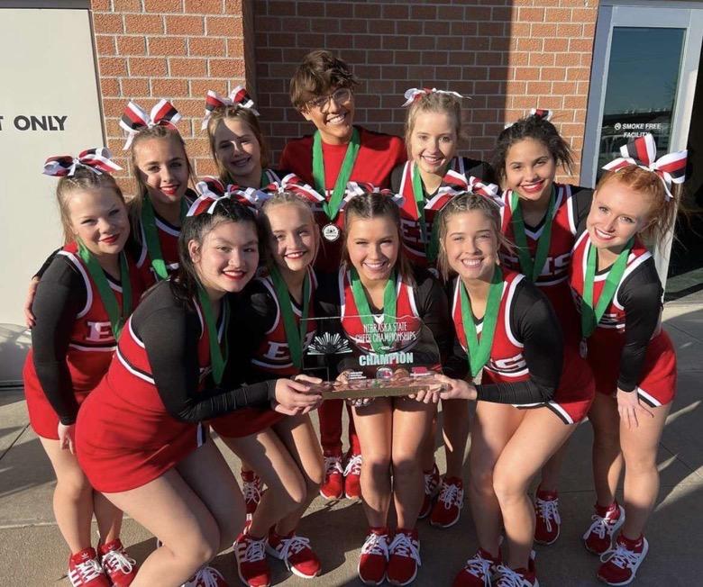 The cheer team poses with their trophy and medals after winning first place. 