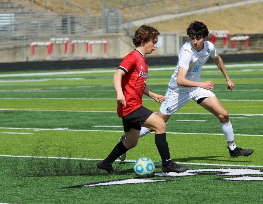 Will Hudson drives the ball upfield against an Elkhorn North defender.