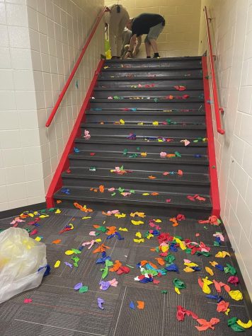 Admin popped all the balloons in the middle stairwell and cleaned up the trash. The balloons were for the senior prank. 
