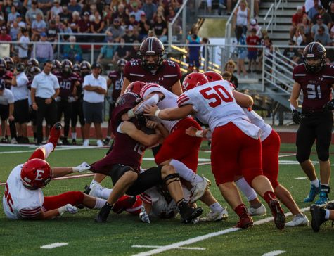A slew of Elkhorn players demolish the Waverly running back.