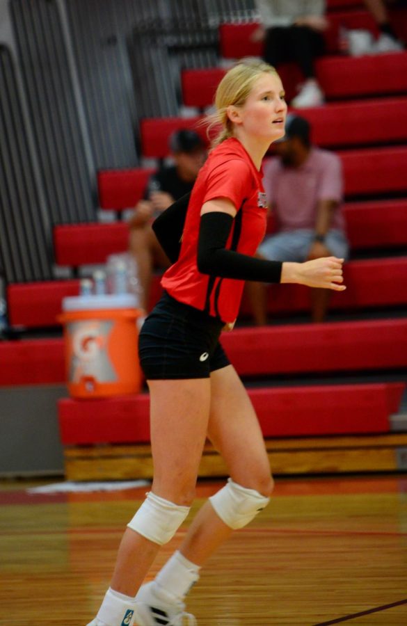 Senior Anna Janvrin running to assume a new position on the court as Omaha Mercy prepares to spike the volleyball. The Antlers won 3 games to 0. 