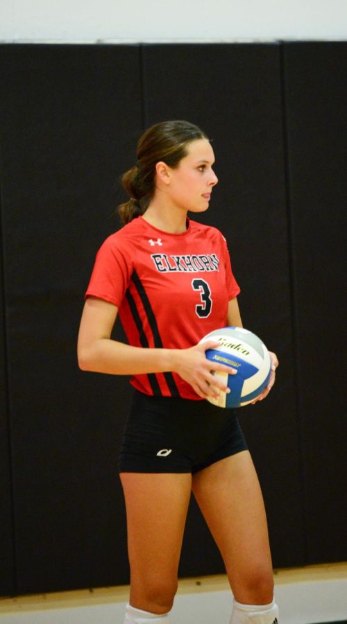 Senior Ella Schutte prepares to serve during the Antlers game against Omaha Mercy. The Antlers won 3 sets to 0. 