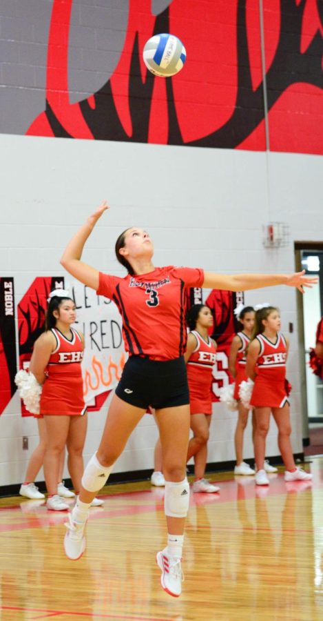 Senior Ella Schute performs an overhand serve against Omaha Mercy. The Antlers won 3 sets to 0. 