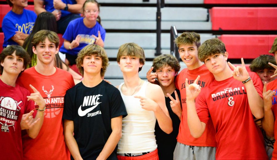 Elkhorns student section posing with the only male member of Omaha Mercys student section (in black), after a volleyball match in which Elkhorn won 3 sets to 0. 