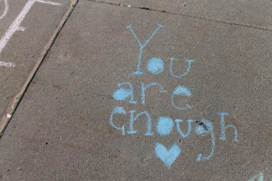 Chalk drawings in the entrance of Elkhorn High from the Chalk it Up event for suicide awareness week.
