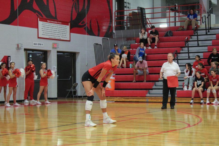 Senior Haley Wolfe prepares to return a serve from Mercy.