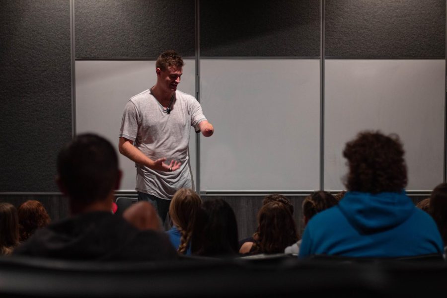 Motivational speaker Kevin Atlas explaining his arm to students.