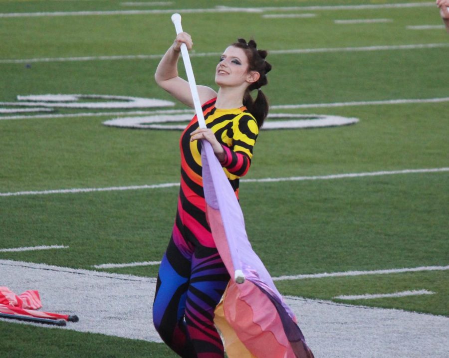 Jocey Logue spins her flag as she performs at state marching band. 