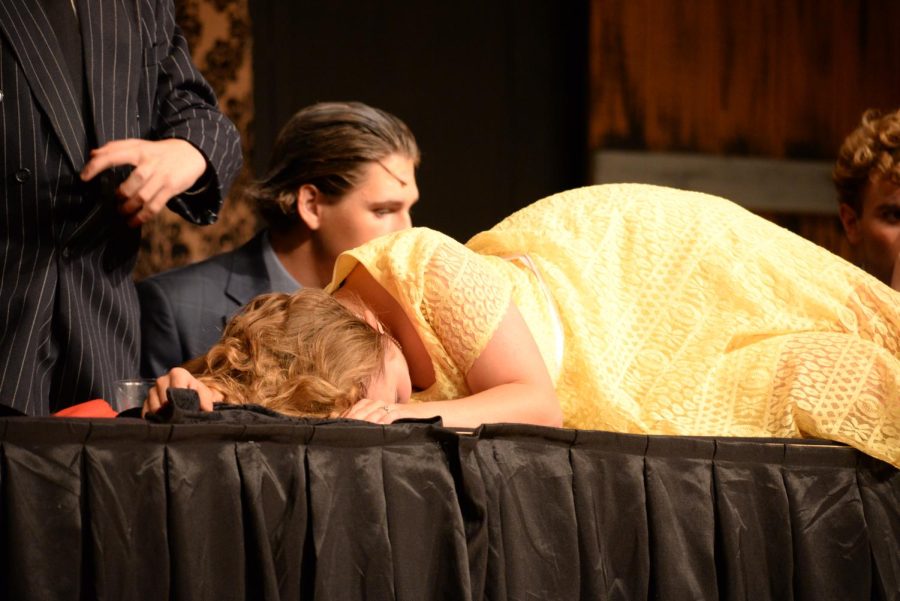 Michaela Todd (Sr), performing as Alice Beineke, having passed out after drinking a magic potion during the Addams Family musical