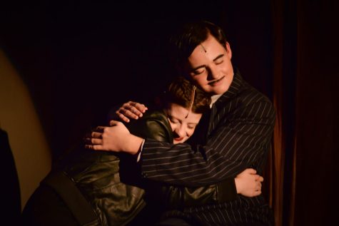 Fischer Kirven (Sr) and Jocey Logue (Sr) hugging near the end of Act I of the dress rehearsal of the Addams Family musical