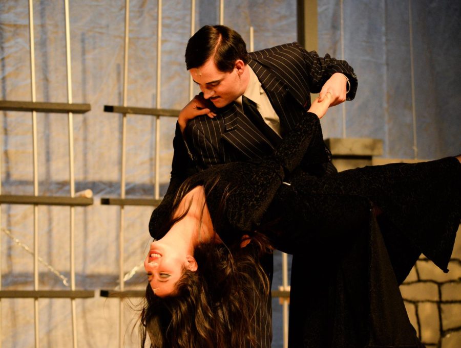 Marielle Cruz (Jr) and Fischer Kirven (Sr) dancing as the characters of Morticia and Gomez Addams during the final resolution of the Addams Family musical