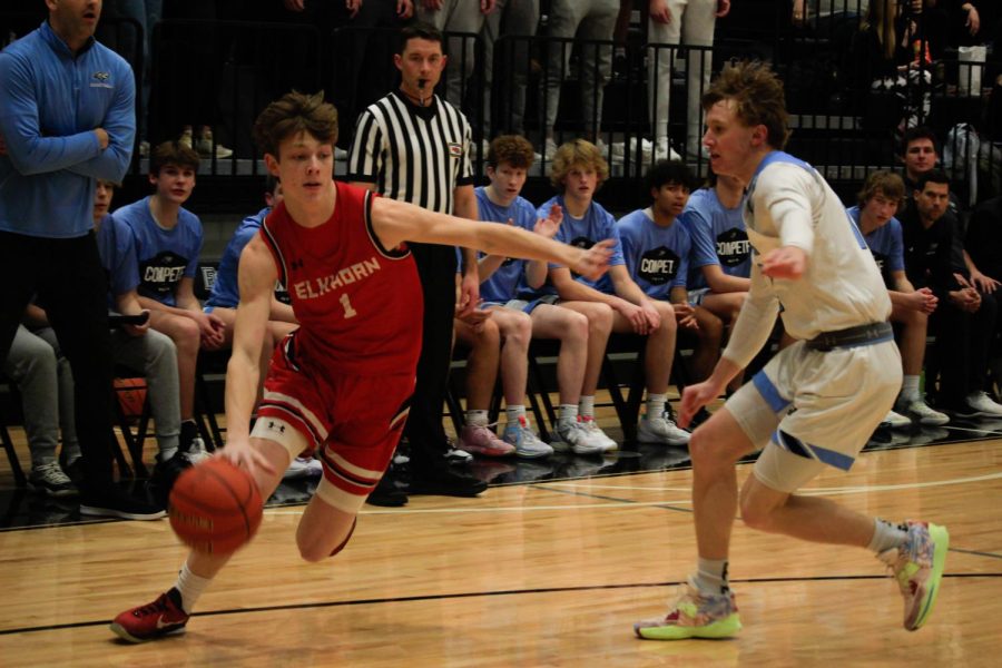 Junior Colin Comstock drives the ball to the Antlers basketball in their game against Elkhorn North. Antlers won 58-49.