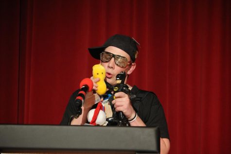 Senior Aiden Sufficool promotes a string of plush bacteria toys during the sell this item portion of the Mr. EHS pageant. He won the competition on March 8th, 2023.