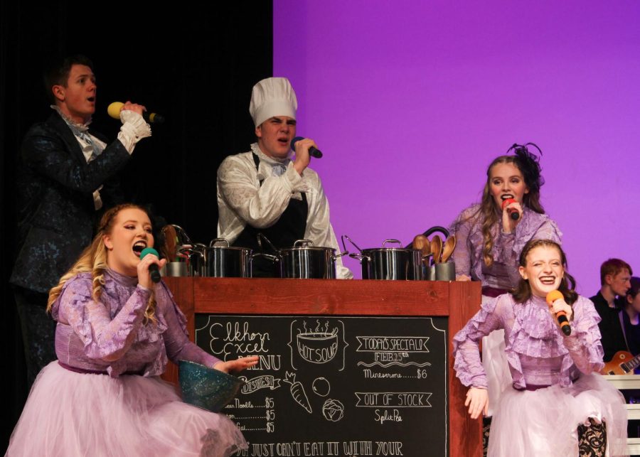 Excel members sing around their soup kitchen. They performed their last show of the season on February 27th. 