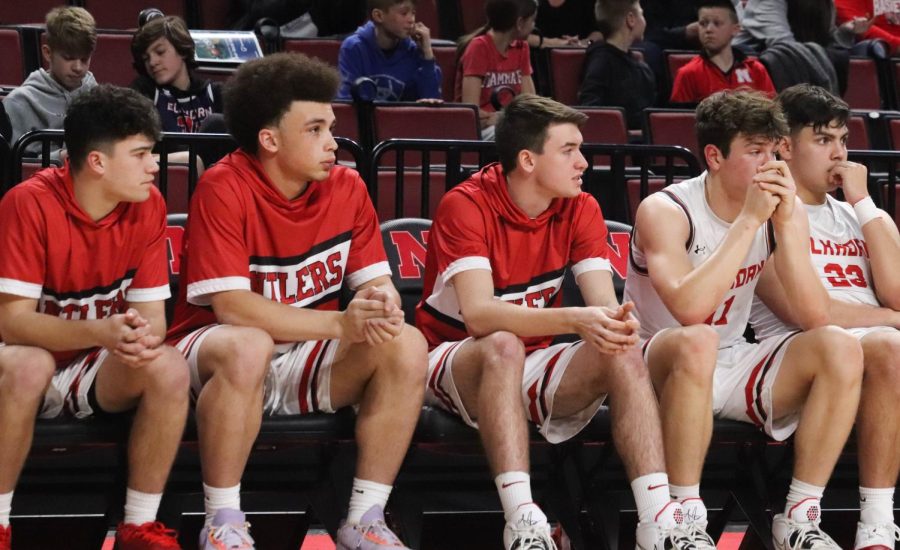 The Antler bench watches their teammates during the first state basketball game. 