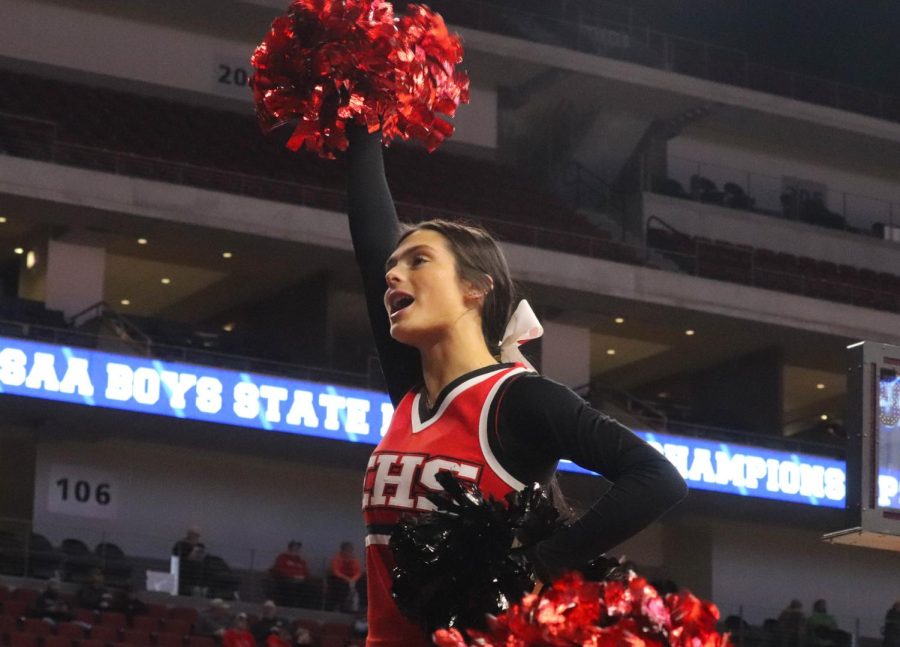 Junior Lily Norton cheers at the first state basketball game. 