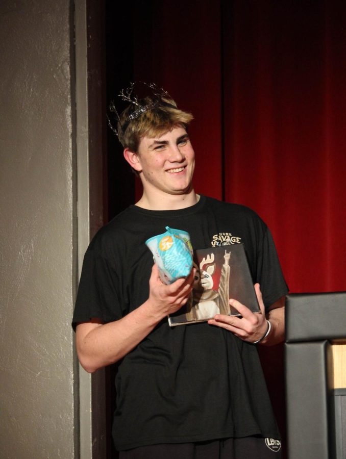 Aiden Sufficool accepts his prizes after he won the title of Mr. EHS. 