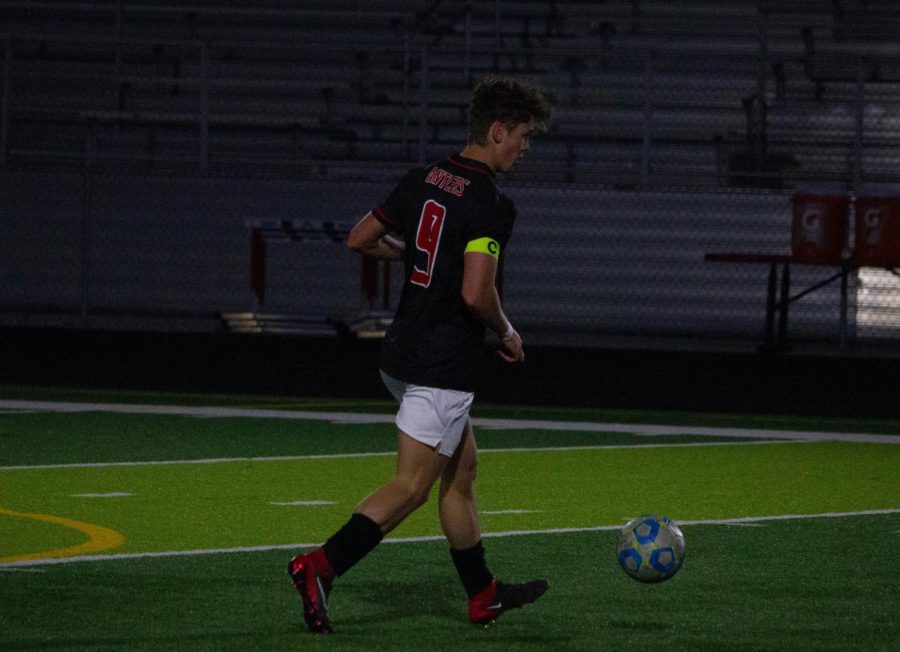 Senior Cole Houck dribbles the ball down the field. 
