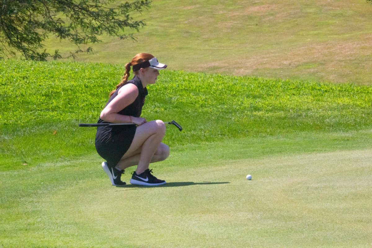 Senior, Alyssa DiNapoli lines her putt up. Antlers beat Waverly in the JV duel on August 29, 2023.