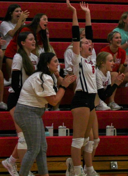 Coach Calle Guthard cheers on her team after scoring a point. Guthard is in her first year of coaching at Elkhorn High School. 