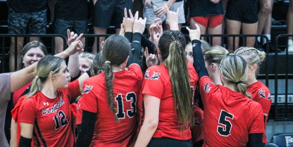 Elkhorn volleyball players put Antlers up during a team cheer. The Antlers played at Elkhorn North.