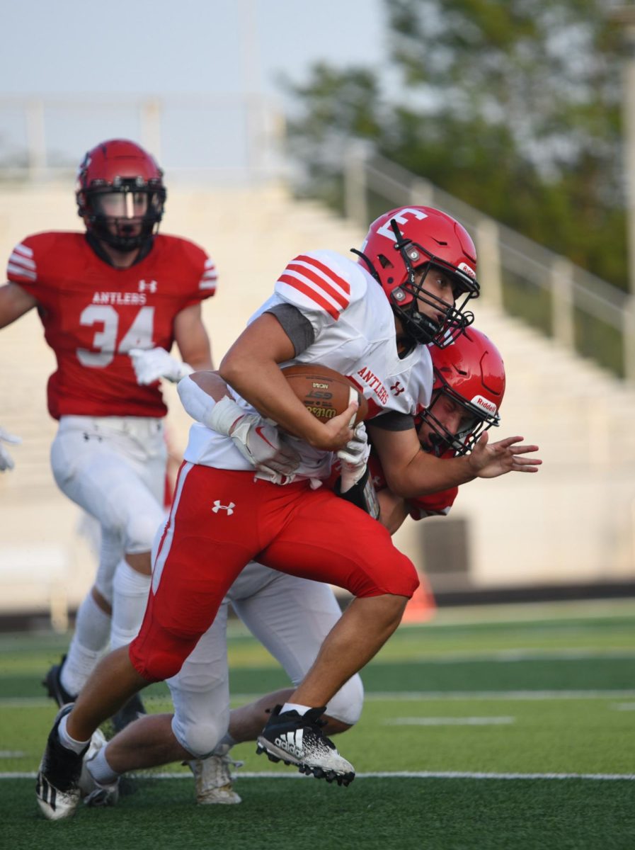 Junior Peyton Turman tackles sophomore Caden Stem during the scrimmage. Red beat White 62-7 on Friday, August 18th.