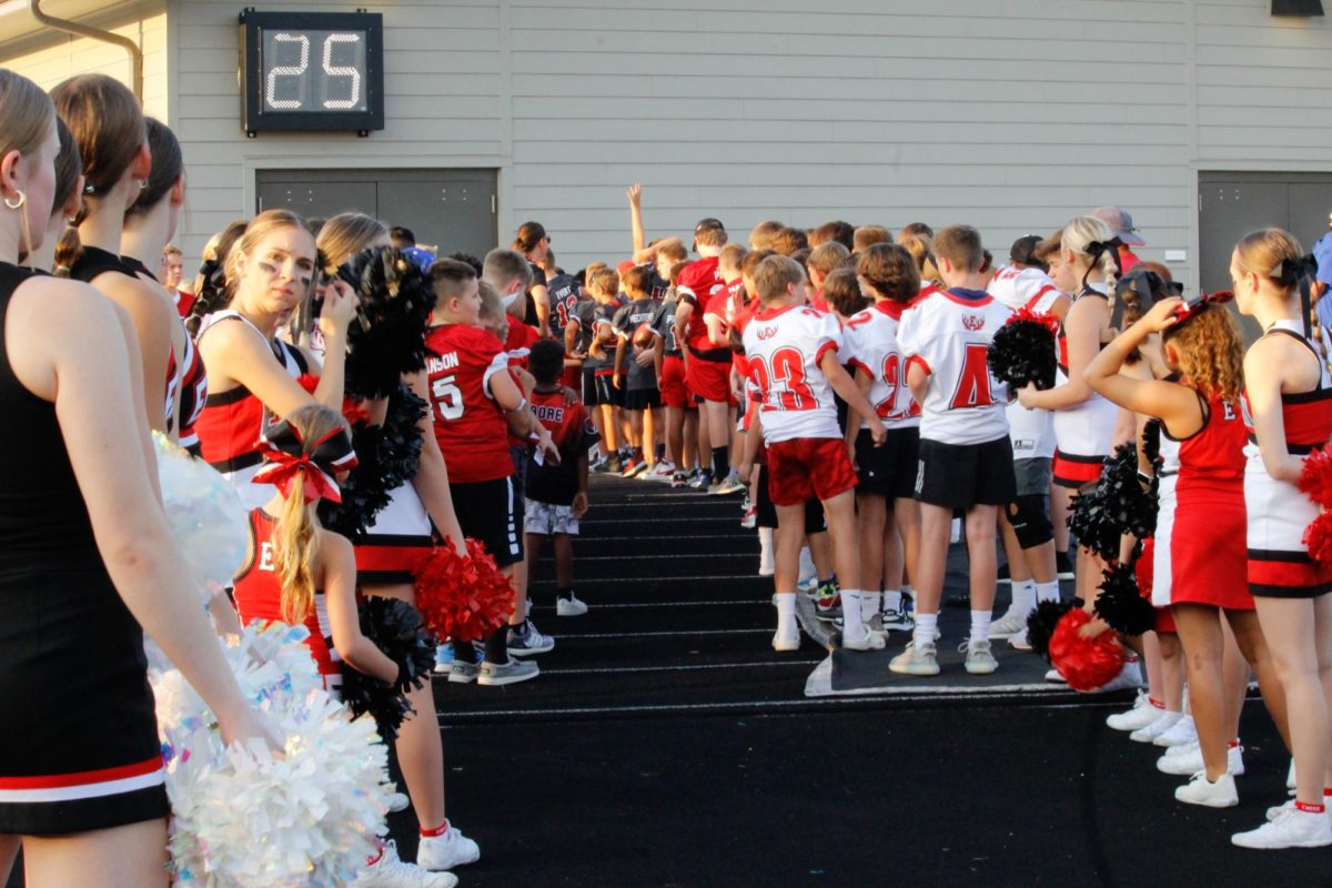 Junior antler and Junior cheerleaders join the Elkhorn high Cheerleaders and the dance team to welcome the football team to the field. The juniors were waiting patiently for the team make their entrance. 