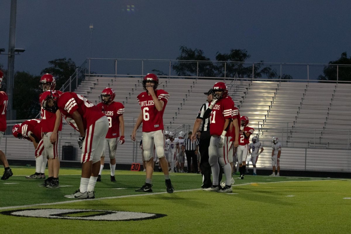 Freshman Hunter Hamilton and freshman Carson Lane look for a call by Coach Winings. Freshman Antlers lost 35-7 to Norris.                                                                                         