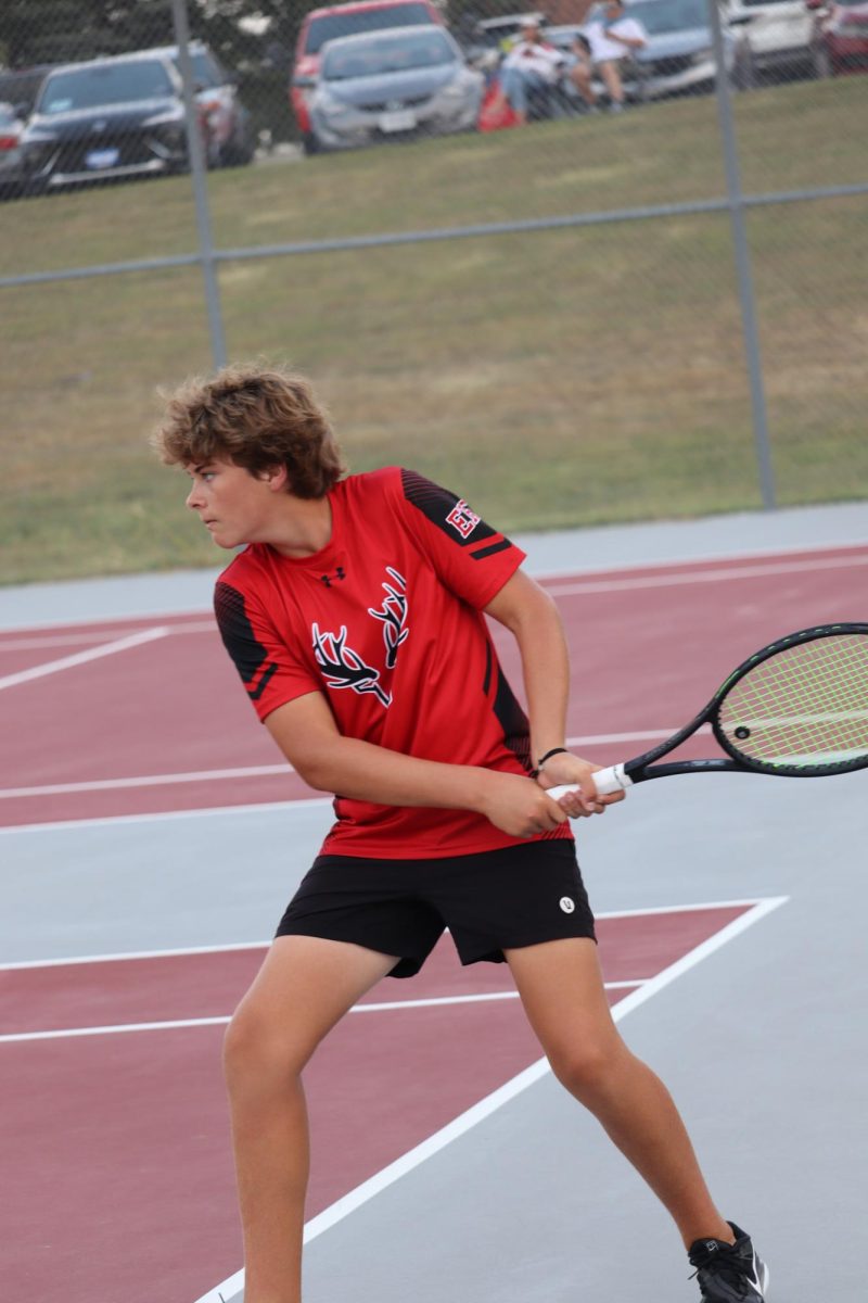 junior Brody Brummer gets ready for the backhand hit. Brummer gets defeated 3-6