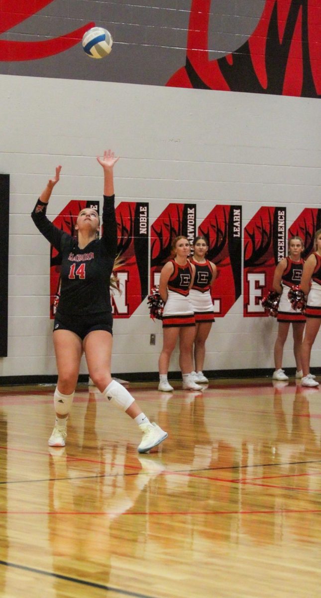 Senior Abby Roberts tosses up the ball for her serve. Abby is a veteran on varsity and leads the team as a middle.