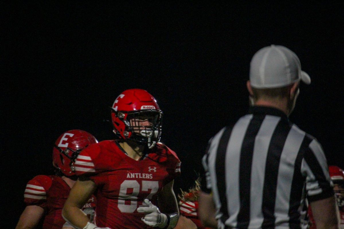 Junior Charlie Lamski runs in to talk to coach Feickert. Lamski is a wide receiver for the Antlers.