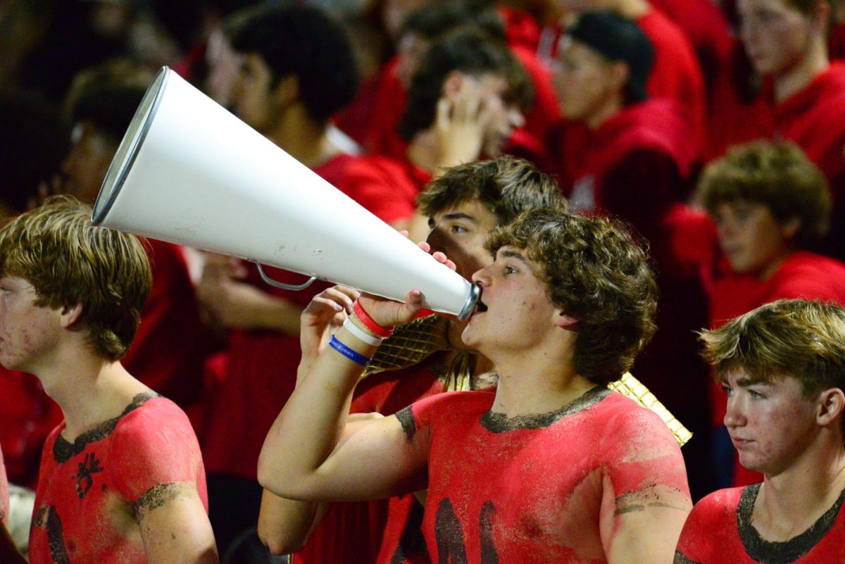 Senior Ryan Ellison shouts through a megaphone. The Antlers lost to the Badgers 28-7 on Friday, September 22nd.