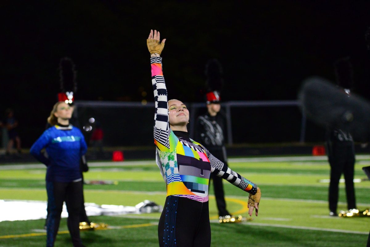 Senior Darla Crews waves to the crowd before the marching band performs their show. The Pride of the Antlers got second in their class and 11th overall at state on Saturday, October 21st. 