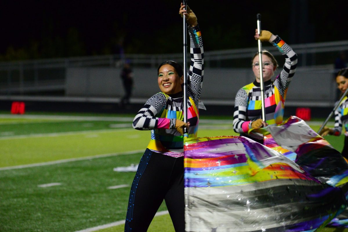 Senior Marielle Cruz spins her flag during the marching band halftime show. The Pride of the Antlers got second in their class and 11th overall at state on Saturday, October 21st. 