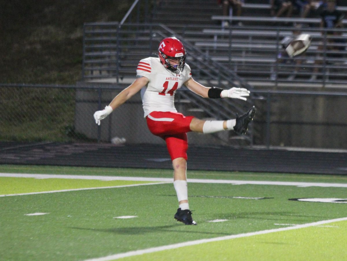 Junior Peyton Turman kicks the ball to the receiving team. Elkhorn lost to Elkhorn North 35-17 on Friday, September 29th.