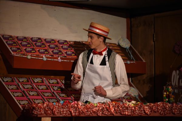 The Candyman (Jonah Lagrange) sings  to the Candy Kids in the 2023 musical Willy Wonka. LaGrange is a senior involved in choir, show choir and theater.