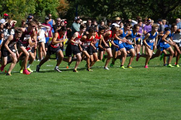 The boys cross country team races to the front of the pack at the start of the state cross country meet in Kearney.